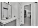 Modern bathroom features a floating vanity and opens to a kitchenette in the background at 275 Canterwood Ln, Mulberry, FL 33860