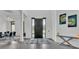 Bright foyer with tile flooring, modern art, and decorative rug leading to a dining area at 275 Canterwood Ln, Mulberry, FL 33860