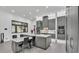 Modern kitchen featuring gray cabinetry, an island with seating, and stainless steel appliances at 275 Canterwood Ln, Mulberry, FL 33860