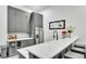 This kitchenette features gray cabinetry, a white countertop, a wine fridge, a sink, and a white backsplash at 275 Canterwood Ln, Mulberry, FL 33860