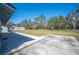 View of backyard featuring a concrete patio and green space at 2926 Delrose N Dr, Lakeland, FL 33805