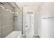 Bathroom featuring shower and tub combination and tiled walls at 2926 Delrose N Dr, Lakeland, FL 33805