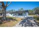 Charming single-story home with a brick exterior, well-maintained lawn, and complementary blue shutters at 2926 Delrose N Dr, Lakeland, FL 33805