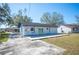 View of the home exterior with a concrete patio and a grassy backyard at 2926 Delrose N Dr, Lakeland, FL 33805