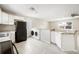 Well-lit kitchen and laundry area showcases stainless appliances, granite countertops, and modern tile flooring at 2926 Delrose N Dr, Lakeland, FL 33805