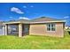 Home exterior showcasing a screened patio in a spacious backyard setting with ample green space and privacy at 300 Lake Smart Cir, Winter Haven, FL 33881