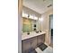 Bright bathroom featuring a double vanity, sleek fixtures, and a glass-enclosed shower at 300 Lake Smart Cir, Winter Haven, FL 33881