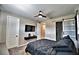 Bedroom boasting neutral walls, a ceiling fan, a TV, and a sliding barn door at 300 Lake Smart Cir, Winter Haven, FL 33881