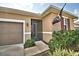 Close up of the front door, front yard and attached two car garage at 300 Lake Smart Cir, Winter Haven, FL 33881