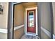 Close up of the front door showing a welcome mat and half-glass window at 300 Lake Smart Cir, Winter Haven, FL 33881