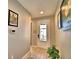 Hallway featuring light gray walls, decorative accents, and view of the front door at 300 Lake Smart Cir, Winter Haven, FL 33881