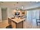 Open floor plan with a kitchen island, pendant lighting, and sliding glass doors to the lanai at 300 Lake Smart Cir, Winter Haven, FL 33881