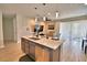 Open concept living area with a kitchen island, pendant lighting, and sliding glass doors to the lanai at 300 Lake Smart Cir, Winter Haven, FL 33881