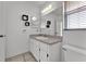 Clean bathroom with a vanity featuring sleek fixtures, modern lighting, and decorative square accents at 3102 Pebble Bend Dr, Lakeland, FL 33810