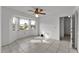 Well-lit bedroom with tiled floors, bay window, and doorway to another room at 3102 Pebble Bend Dr, Lakeland, FL 33810