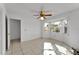 Bright bedroom featuring tile floors, a ceiling fan, and a bay window letting in natural light at 3102 Pebble Bend Dr, Lakeland, FL 33810