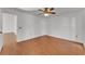 Bright bedroom with ceiling fan and warm wood-look laminate flooring at 3102 Pebble Bend Dr, Lakeland, FL 33810