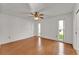 Bedroom features gleaming hardwood floors, ceiling fan, and bright windows at 3102 Pebble Bend Dr, Lakeland, FL 33810