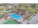 Aerial view showcasing a community center with a pool and a tennis court at 3102 Pebble Bend Dr, Lakeland, FL 33810