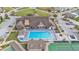 Aerial view of a community clubhouse with a large pool, tennis court, and putting green, perfect for recreation at 3102 Pebble Bend Dr, Lakeland, FL 33810