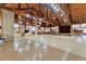 Large event space with wood beamed ceiling, stage and adjacent lounge area at 3102 Pebble Bend Dr, Lakeland, FL 33810