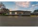 Charming single-story home with white siding and manicured lawn, bathed in the warm light of the setting sun at 3102 Pebble Bend Dr, Lakeland, FL 33810