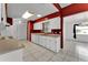 Bright kitchen features white appliances, cabinets, and tile flooring, plus red accent wall at 3102 Pebble Bend Dr, Lakeland, FL 33810