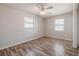 Bedroom featuring laminate floors, bright light from two windows, and neutral paint palette at 320 E Daughtery Rd, Lakeland, FL 33809