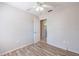 Bright bedroom featuring laminate floors, ceiling fan, and neutral paint palette at 320 E Daughtery Rd, Lakeland, FL 33809