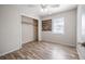 Bedroom showcasing laminate floors, wooden accent decor, and a window at 320 E Daughtery Rd, Lakeland, FL 33809