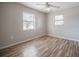 Bedroom featuring laminate floors, bright light from two windows, and neutral paint palette at 320 E Daughtery Rd, Lakeland, FL 33809