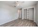 Bedroom featuring laminate floors, closet shelving, and a neutral paint palette at 320 E Daughtery Rd, Lakeland, FL 33809