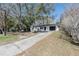 Charming single-story home with black garage door, front door, and a long driveway at 320 E Daughtery Rd, Lakeland, FL 33809