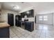 Black appliance kitchen open to living area, with tile flooring at 320 E Daughtery Rd, Lakeland, FL 33809