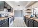 Well-lit kitchen with black cabinets, stainless steel oven, and wood countertops at 320 E Daughtery Rd, Lakeland, FL 33809