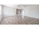 Spacious living room featuring modern light wood laminate flooring and ceiling fans at 320 E Daughtery Rd, Lakeland, FL 33809