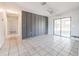 Bright, tiled living area with sliding glass door access to a screened porch at 320 E Daughtery Rd, Lakeland, FL 33809