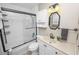 This full bathroom features a shower/tub, a vanity, decorative lights and mirror and a tiled shower surround at 327 Corona Del Mar St, Lakeland, FL 33809