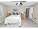 A cozy bedroom shows calming gray floors, a plush bed with neutral tones, and natural light from the window at 327 Corona Del Mar St, Lakeland, FL 33809