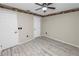 A simple bedroom provides modern flooring, a ceiling fan, and access to two closets at 327 Corona Del Mar St, Lakeland, FL 33809