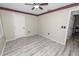 A comfortable bedroom with wood-look floors, a ceiling fan, and a decorative border at 327 Corona Del Mar St, Lakeland, FL 33809