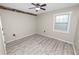 Simple bedroom shows modern flooring, a ceiling fan, and a bright window at 327 Corona Del Mar St, Lakeland, FL 33809