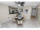 Bright dining room with a modern ceiling fan, a round dining table, and adjacent kitchen at 327 Corona Del Mar St, Lakeland, FL 33809