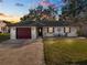 Charming one-story home with a well-manicured lawn and decorative shutters at 327 Corona Del Mar St, Lakeland, FL 33809