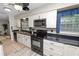 Kitchen boasting white cabinetry, modern appliances, and bright natural light at 327 Corona Del Mar St, Lakeland, FL 33809
