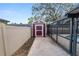 New shed with painted door adjacent to an enclosed pool at 327 Corona Del Mar St, Lakeland, FL 33809