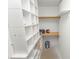 A well-organized walk-in closet boasts extensive shelving and storage space, enhancing functionality at 327 Corona Del Mar St, Lakeland, FL 33809