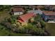 An aerial view of a house showcasing its backyard, landscaping, screen patio, and the surrounding neighborhood at 3978 Viamonte Ln, Lakeland, FL 33810