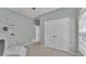 Light and airy bedroom featuring a closet with double doors, with decor shelves on the wall at 3978 Viamonte Ln, Lakeland, FL 33810