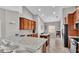 Bright kitchen featuring granite countertops and wooden cabinetry, perfect for cooking and entertaining at 3978 Viamonte Ln, Lakeland, FL 33810